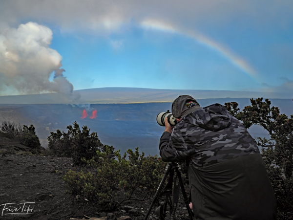 Tour Guide Shooting Lava Flows with Rainbow Overhead