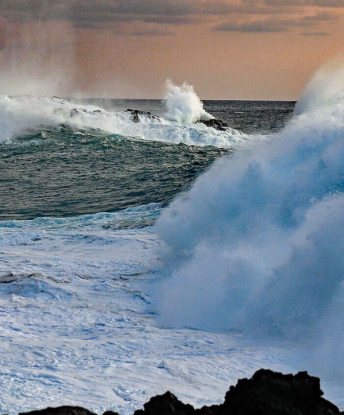 Large Wave Crashing Among Black Rocks on Hawai'i